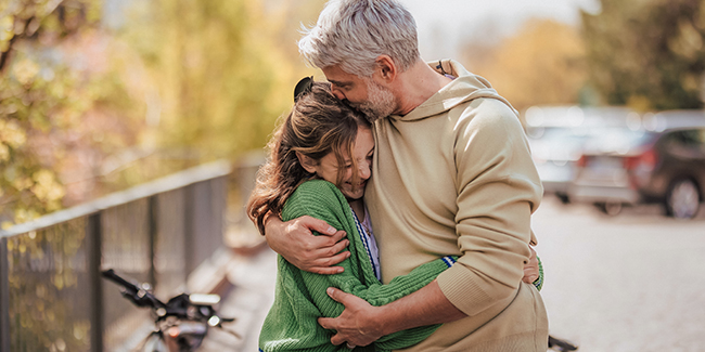 dad hugging teen daughter