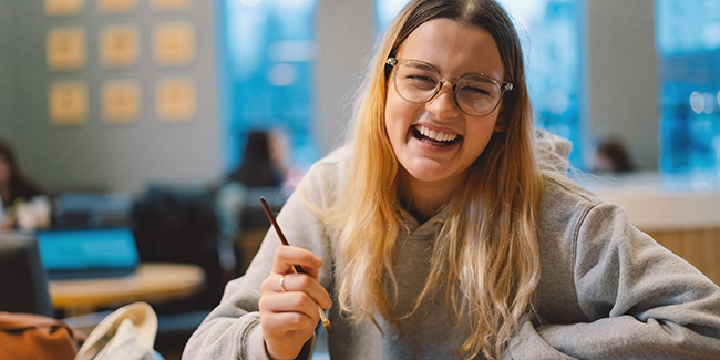 Teen girls smiling while painting