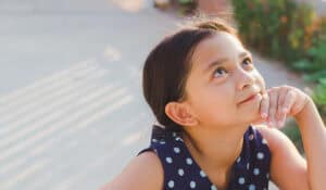 Girl looking up with wonder.