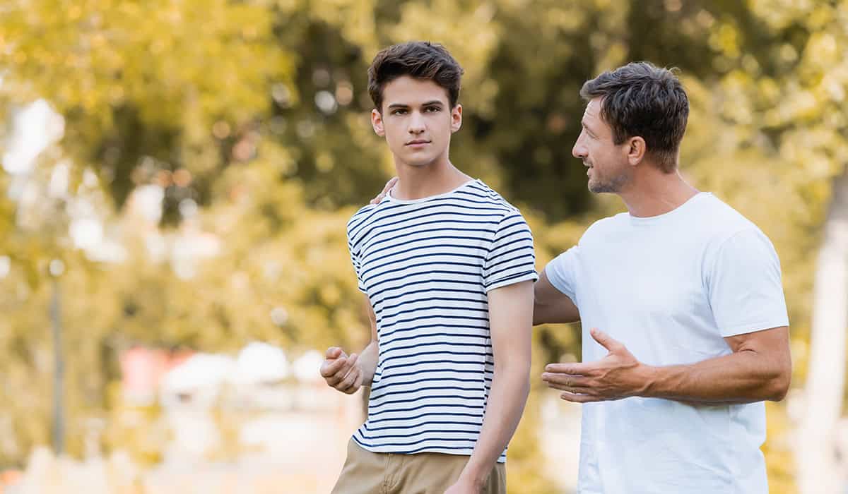 Father and son walking and having a conversation