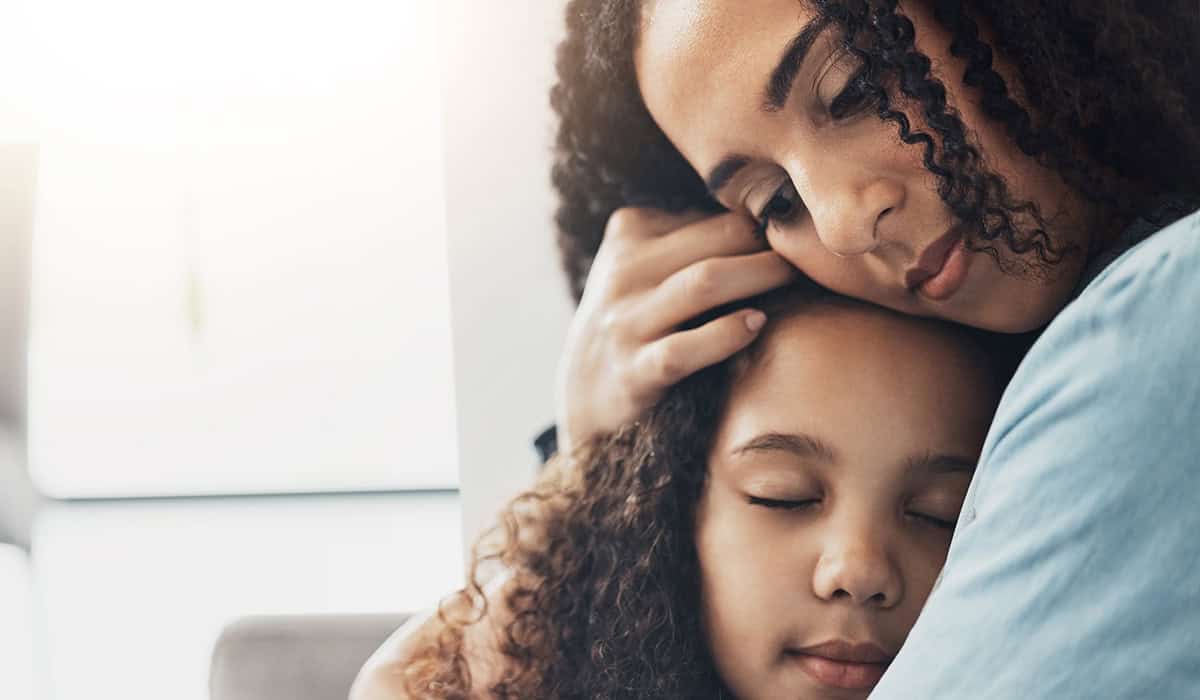 mother comforting daughter